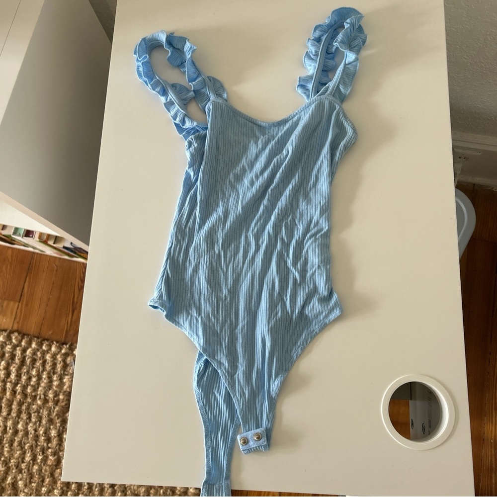 Light blue body suit with ruffle straps